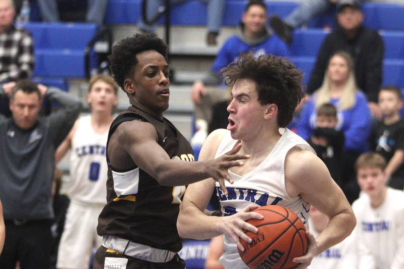 Burlington Central’s Matthew Lemon looks for an option as Jacobs’ Amari Owens plays defense in varsity boys basketball at Burlington Tuesday night.
