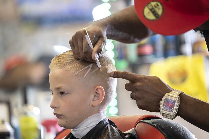 Ben Phillips gives Colton Lee a little pizzazz in his new cut Tuesday, July 30, 2024.