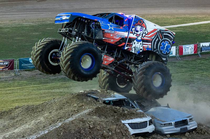Driver of the Monster Truck 'Rescue Racer' flies over 2 cars and ramp at the Monster Truck Bash on Saturday, Sept. 13, 2025 at the La Salle Speedway in La Salle.