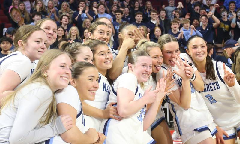 Members of the Nazareth girls basketball team pose for a photo after winning the Class 4A State girls basketball championship game on Saturday, March 7, 2026 at CEFCU Arena in Normal.