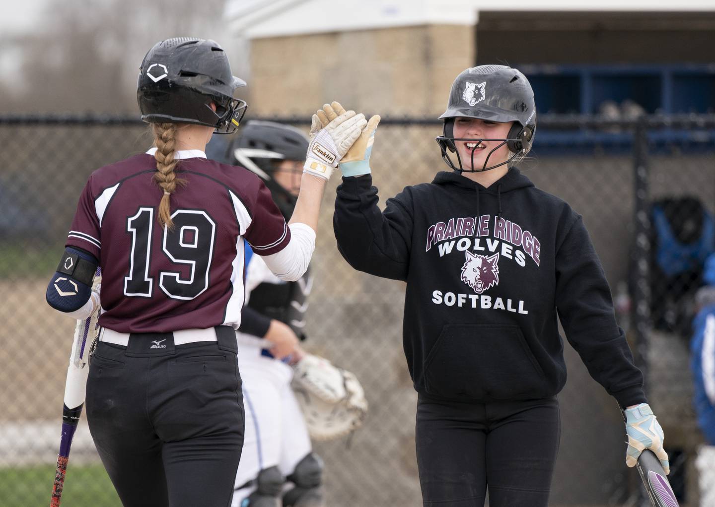 Prairie Ridge's Kendra Carroll, left, congratulates Adysen Kiddy after she scored a run during their game against Burlington Central on Wednesday, April 27, 2022 at Burlington Central High School.