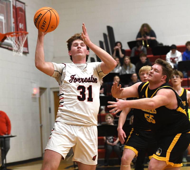 Forreston's Brennan Byers reaches for the ball as AFC's Lane Messer reacts on Saturday, Jan. 17, 2026 at Forreston High School.