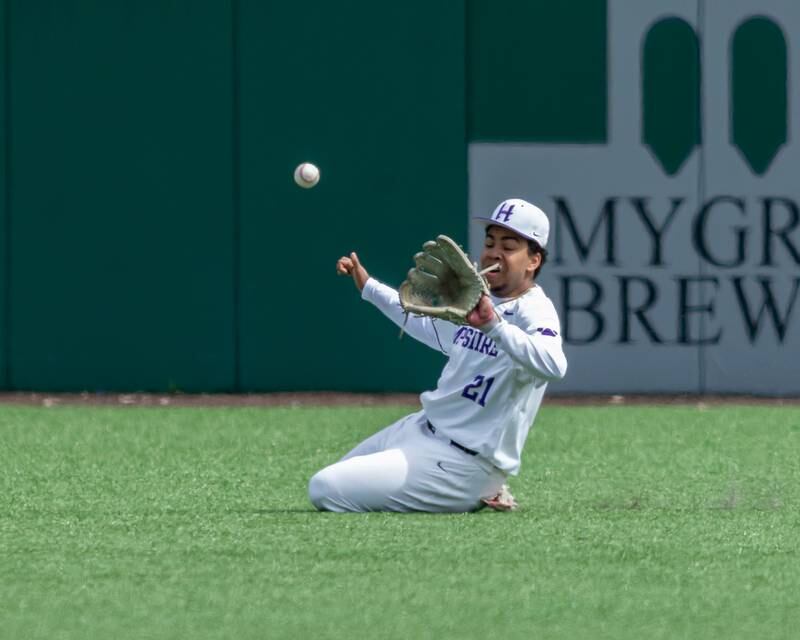 Hampshire's Wilson Wemhoff (21) makes a sliding catch in right field during baseball game between Dixon at Hampshire.  March 28, 2024