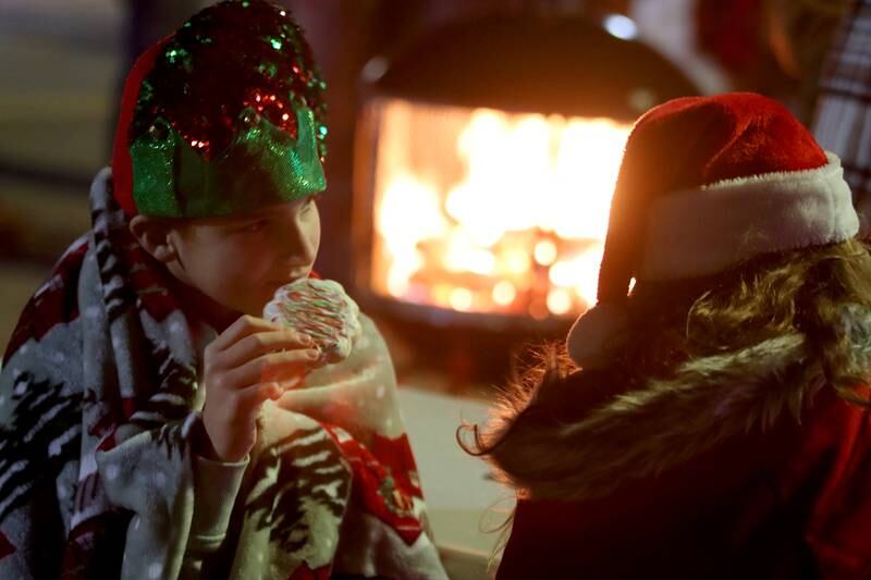 Kendall Kaiser, left, of Huntley enjoys a cookie with her friend Ellie Wolfe of Marengo as part of holiday events Saturday, Dec. 7, 2024 in downtown Marengo.