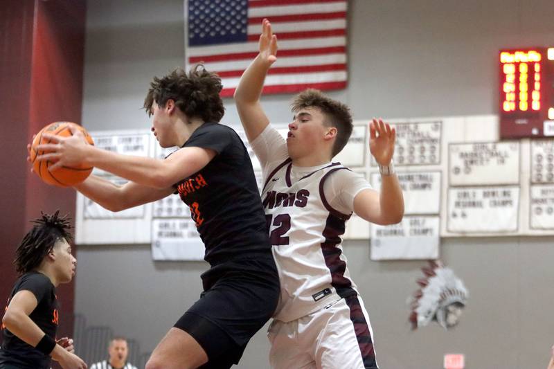 Marengo’s Sam Vandello, right, battles Sandwich’s Charles Behringer for the ball in varsity boys basketball action on Saturday, Jan..24, 2025, at Marengo High School in Marengo.