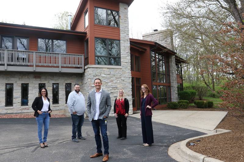 Northern Illinois Recovery Center managing partner Chris Reed, front, poses for a photo with (back, from left:) Director of Finance Lee Ann Rodriguez, Operations Director Jesse Cervantes, Clinical Supervisor Jenny Wagner, and Clinical Director Caitlyn McClure at their newly purchased facility located at 2602 Route 176 on Friday, May 7, 2021, in Prairie Grove.  The building is currently occupied by Dorian Gray Professional Wealth Advisors but will become a 16-bed, 30-day residential detox facility for the NIRC.