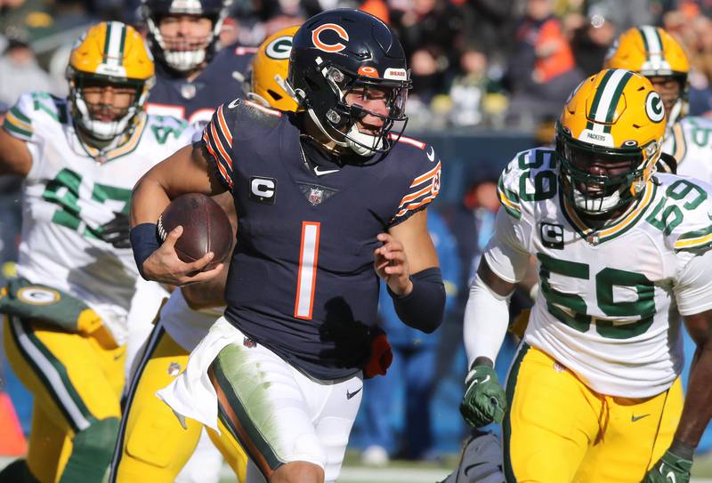Chicago Bears quarterback Justin Fields breaks through the Green Bay Packers defense for a long touchdown run during their game Sunday, Dec. 4, 2022, at Soldier Field in Chicago.