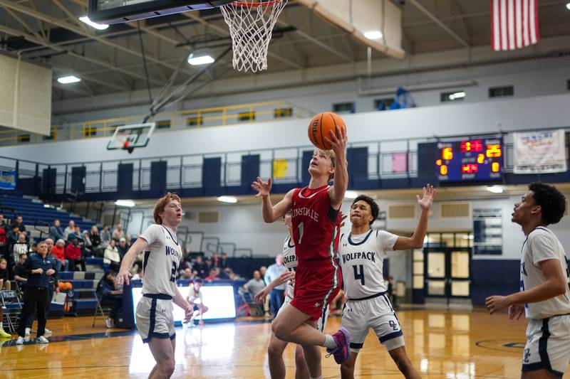 Hinsdale Central's Eric Kozys (1) shoots the ball in the post against Oswego East's Lukas Adolfs (12) and Myles Buchanan (4) during a hoops for healing tournament basketball game at Oswego High School on Tuesday, Nov. 26, 2024.