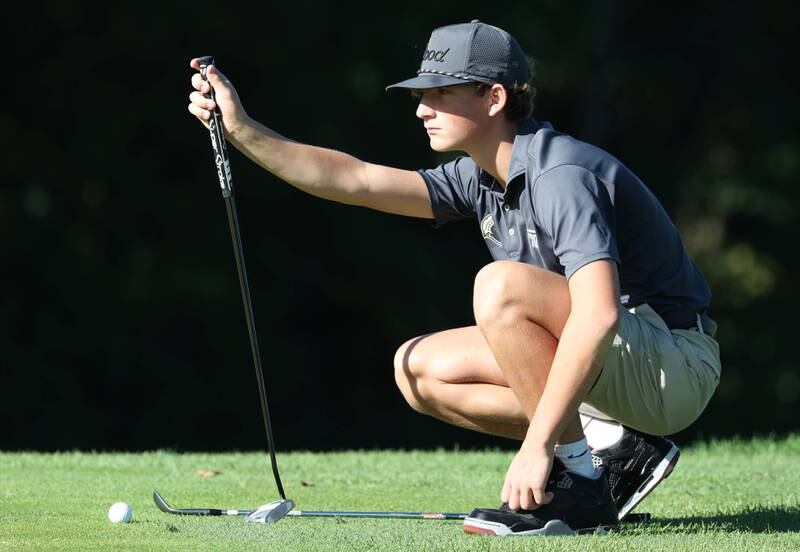 Sycamore’s Eli Goodeill lines up a putt from the fringe of the third green Monday, Sept. 23, 2024, during the Interstate 8 boys golf tournament at the Kishwaukee Country Club in DeKalb.