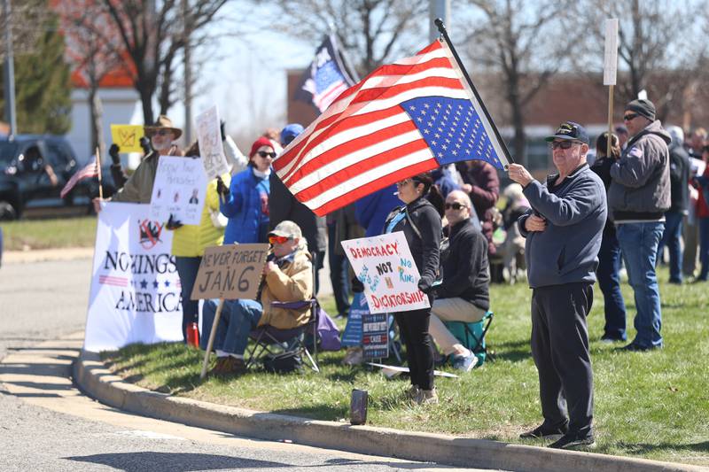A man hold an upside down flag as a symbol of a nation in crisis at the No Kings rally on Saturday, March 28, 2026 in Joliet.