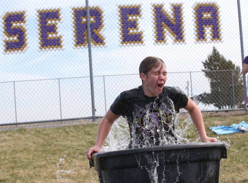 Parker Twait hops in a bucket of cold water during the Polar Plunge for Special Olympics on Friday, March 21, 2025 at Serena High School.