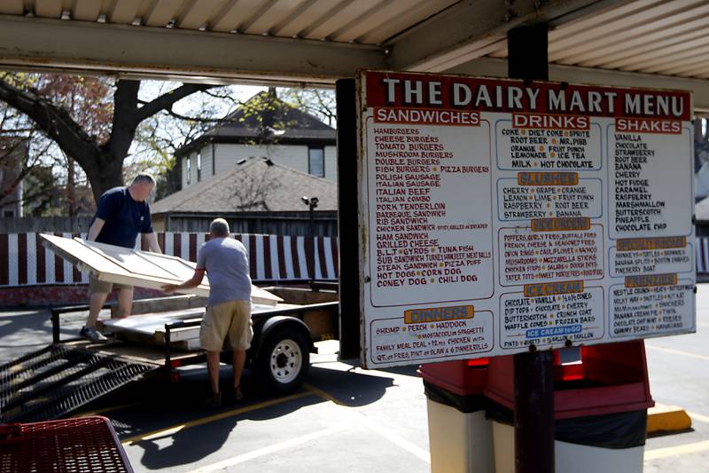 Bill Dunn, who recently purchased the Huntley Dairy Mart on Route 47 in Huntley, works with John Wean to carry a winter panel from the restaurant to a trailer on Friday, April 14, 2023, as they prepare to reopen the Dairy Mart after it closed in February.