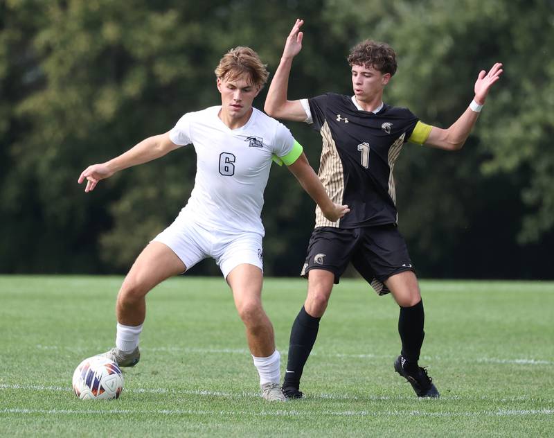 Kaneland's Noah McKittrick tries to hold off Sycamore's Noah Daykin during their game Monday, Oct. 6, 2025, at Sycamore High School.