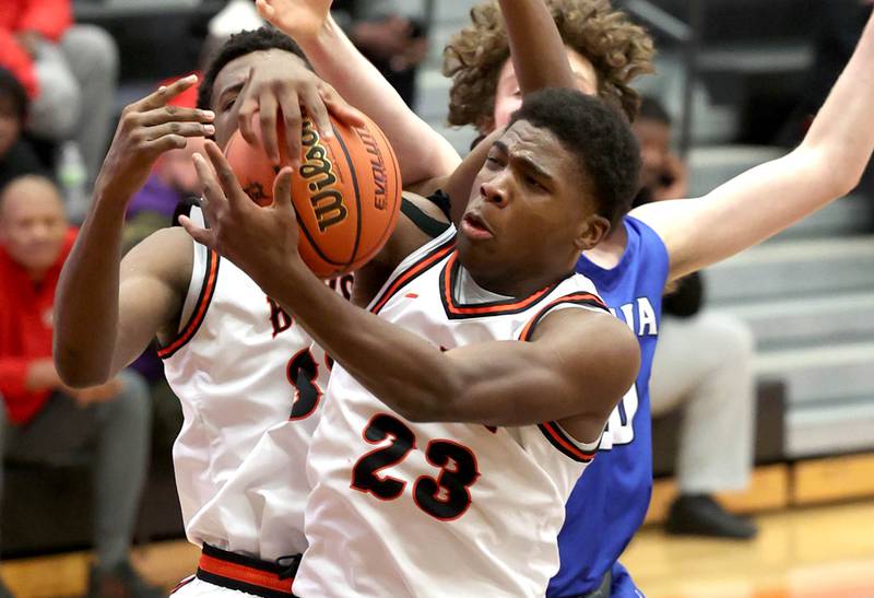 DeKalb’s Davon Grant grabs a rebound in front of Geneva’s Andrew Conley Thursday Dec. 28, 2023, during their second round game in the 96th Chuck Dayton Classic boys basketball tournament at DeKalb High School.