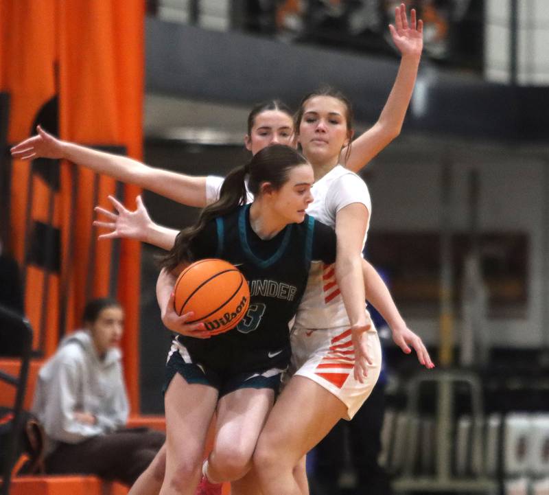 Crystal Lake Central’s Jordyn Johnson, back right, guards Woodstock North’s Adelyn Crabill, front, in varsity girls basketball on Monday, Jan. 26, 2026, at Crystal Lake Central High School in Crystal Lake.