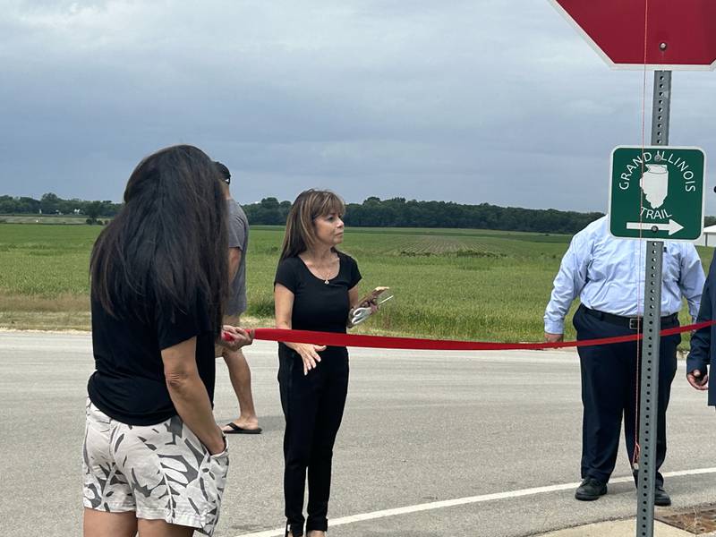 Harvard Alderwoman Rosa Luna, 4th Ward, cuts ribbon on Saturday, June 8, 2024, during the ceremony naming the entrance to Milky Way Park after her father, V.H. Garza. The Garza family was one of the first Spanish-speaking families  in Harvard.