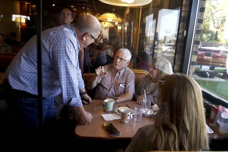 David MacPhail, right, of Wauconda, talks with Republican candidate for governor Darren Bailey as Bailey campaigns Wednesday, Sept. 21, 2022, at the Around the Clock Restaurant, 5011 Northwest Highway, in Crystal Lake, during a nine-city bus tour, with his Lt. Governor candidate Stephanie Trussell.