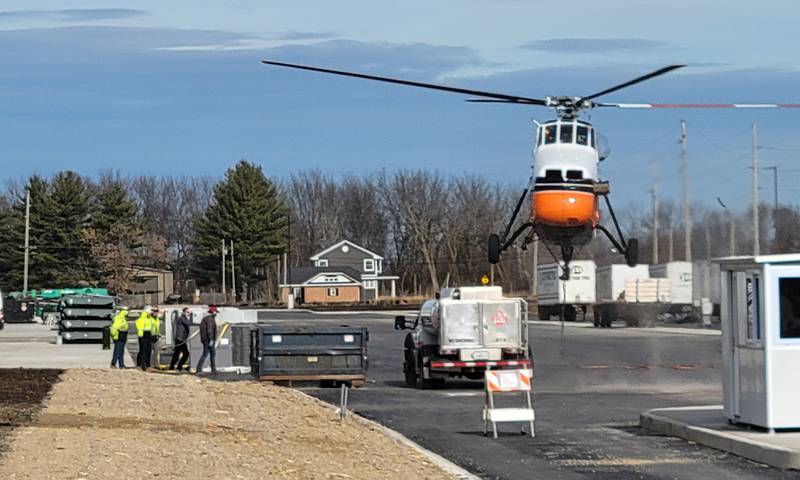 A 1962 Sikorsky helicopter lifts off before carrying 10 heating and air conditioning units onto the roof of the new Ollie’s Bargain Outlet warehouse near the intersection of Interstate 80 and Illinois Route 26 in Princeton on Friday morning. The helicopter, according to an employee of Midwest Helicopters in Willowbrook, has a maximum lifting capacity of 5,000 pounds, so it managed to handle with ease the units that ranged in weight from 1,000 to 2,500 pounds in less than half an hour.