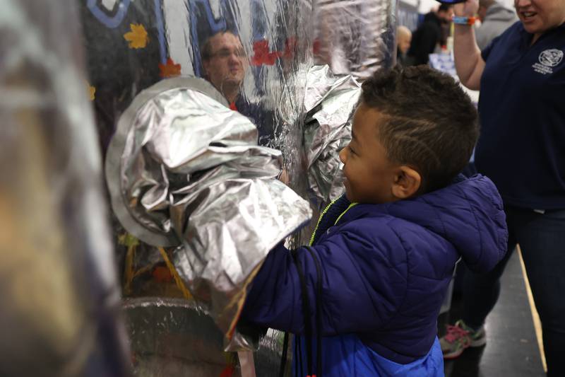 Thomas Doe, 7, tries to grab blowing leaves at the Will County Emergency Management Agency vendor at the Will County Executive 2024 Kids’ Fair at Troy Middle School in Plainfield on Monday, Feb. 19, 2024.