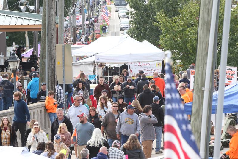 People walk down Mill Street for the 53rd annual Burgoo on Sunday, Oct. 8, 2023 downtown Utica.