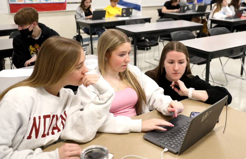 McKenna Kelsay (right) works with Teagan Rokos (left) and Lola Kolaya in a cultural studies class at Batavia High School. Kelsay also serves as the girls varsity volleyball head coach at the school.