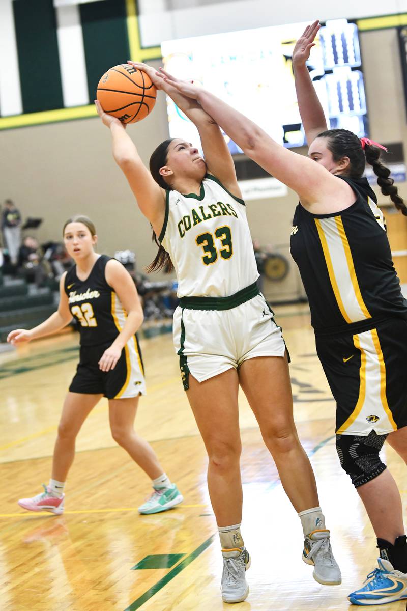 Coal City's Emma Rodriguez shoots under pressure from Herscher's Anistin Hackley Monday, Feb. 3, 2025, during the Coalers' victory over Herscher at Coal City High School.