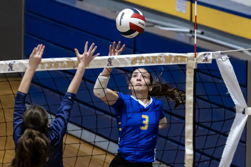 Joliet Central's Delany Moran taps the ball over the net during a varsity volleyball game against Illinois Mathematics and Science Academy at Joliet Central on Oct. 20, 2025.