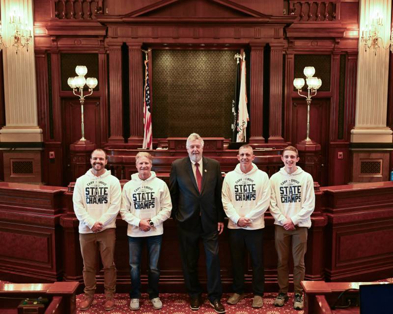 State Rep. Steve Reick poses with players and coaches of the state championship Cary-Grove High School football team after the General Assembly passed a resolution lauding the team on April 10.