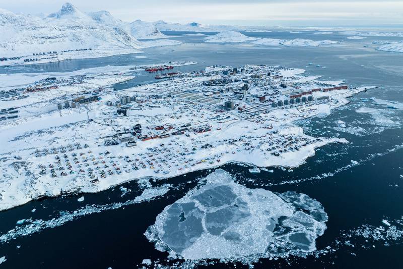 FILE - Houses covered by snow are seen on the coast of a sea inlet of Nuuk, Greenland, on  March 7, 2025. (AP Photo/Evgeniy Maloletka, File)