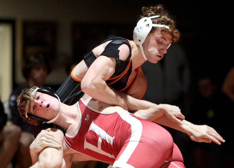 Crystal Lake Central’s Alessio Pezzella, top,  battles Huntley’s Shane McGuine in a 150-pound bout in varsity wrestling at Crystal Lake Friday. Pezzella won the match.