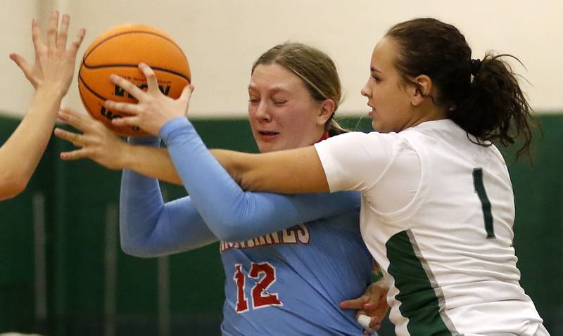 Grayslake Central's Addi Thomas tries to knock the ball away from Marian Central's Abbey Miner during a nonconference girls basketball on Monday, Jan. 13, 2025, at Grayslake Central High School.