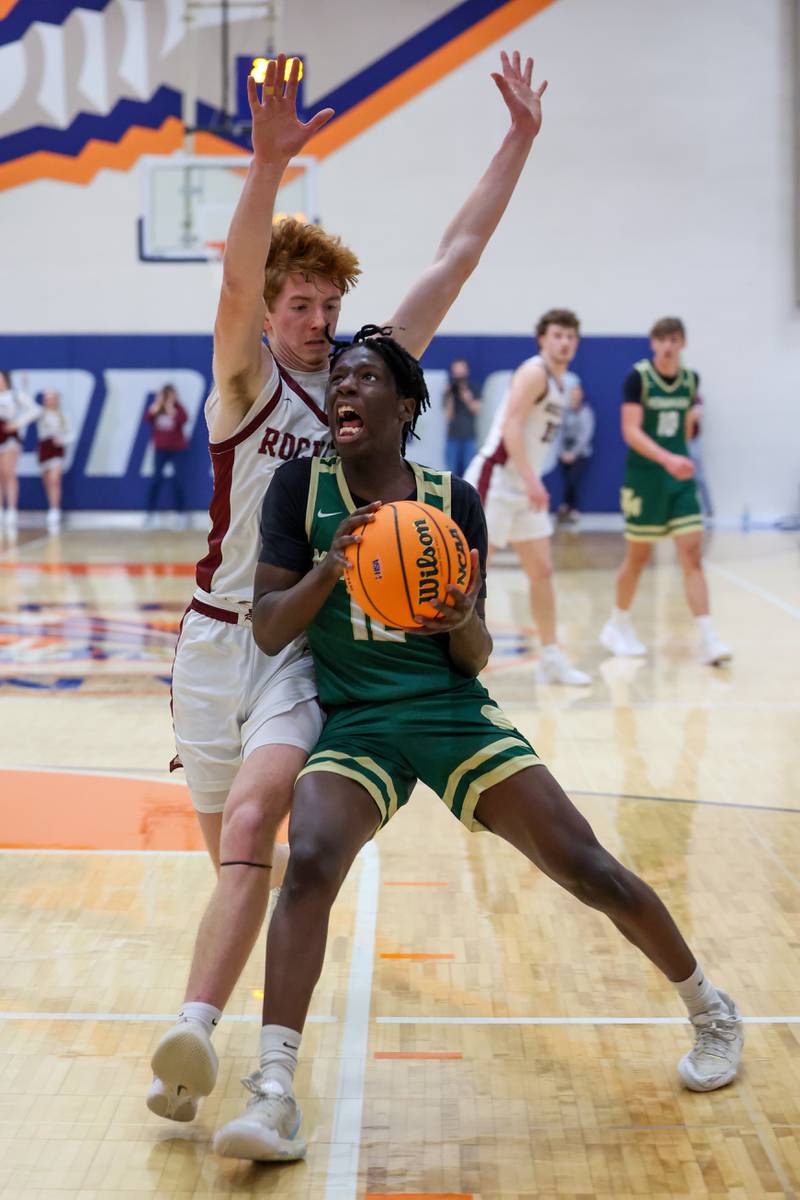 Bishop McNamara's Corey Hathaway drives to the hoop under pressure during the Fightin' Irish's 77-70 loss to Tolono Unity in the IHSA Class 2A Pontiac Supersectional on Monday, March 9, 2026.