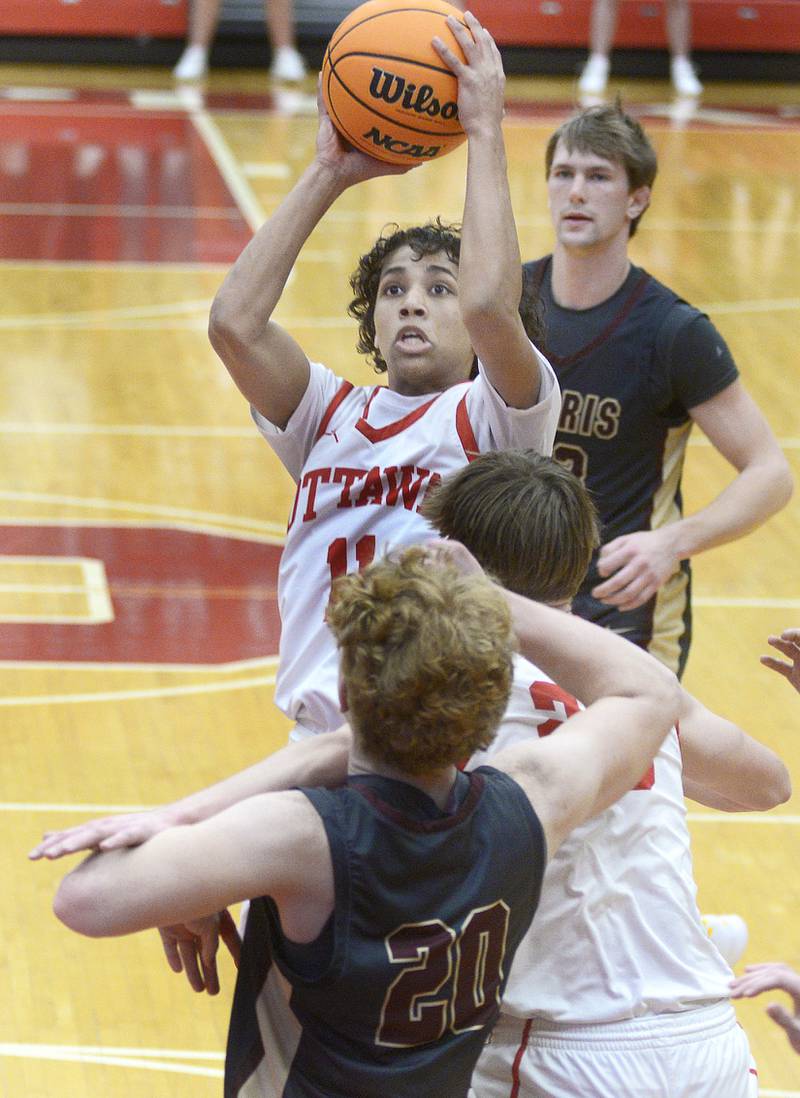 On a drive to the basket, Ottawa’s Hezekiah Joachim shoots over traffic in the 1st period Tuesday at Ottawa.