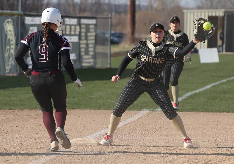 Sycamore's Addison Armstrong catches a throw as they try to pickoff Marengo's Gianna Iovinelli Friday, April 11, 2025, during their game at Sycamore High School.