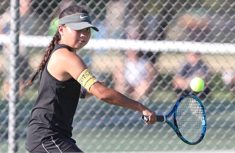 Sycamore's Elizabeth Kleckner hits a backhand during her match against DeKalb's Aubree Judkins Monday, September 19, 2022, at Sycamore High School.