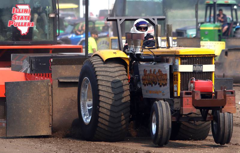 A driver pilots the Alcoholic Haze tractor to a pull on the final day of the 2025 McHenry County Fair in Woodstock on Sunday, August 3, 2025. “Alcoholic Haze” refers to the vehicle’s fuel, which is alcohol.