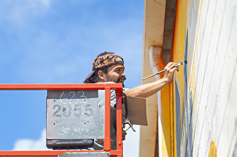 Painter David Orozco works on a portion of the mural Wednesday, Aug. 24, 2022. The work is expected to be done next Tuesday.