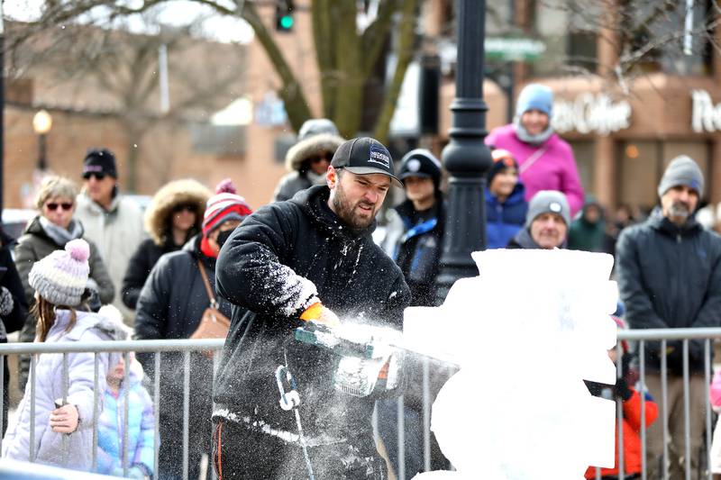 Jack Neiweem of Nadeau’s Ice Sculptures carves a sea horse out of a block of ice during the Downtown Downers Grove Ice Festival on Saturday, Feb. 1, 2025 in Downers Grove.