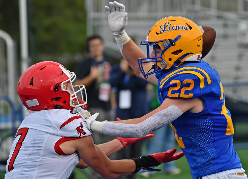 Lyons Township’s Nathan Fitzgerald (22) breaks up a pass intended for Hinsdale Central’s James Skokna (7) during a game on September 20, 2025 at Lyons Township High School in LaGrange.
