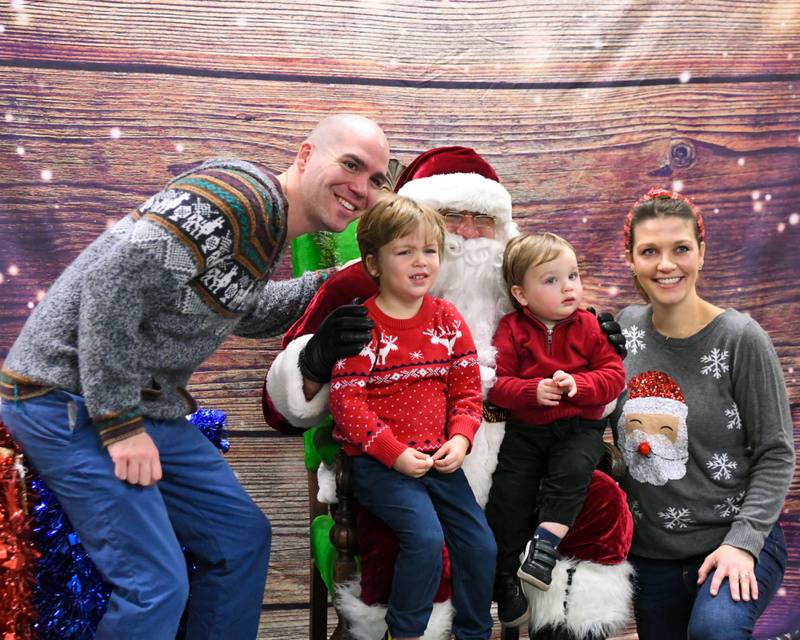 Jackson Kontny along with his wife Megan Kontny and their kids Leo, 3, and Jonah, 1, pose for a photo with Santa during the breakfast with Santa event held on Sunday Dec. 15, 2024, at the La Grange Park District Recreation Center.