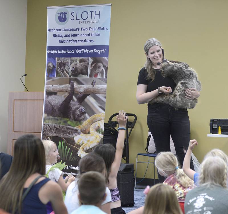 essica Reedy of Animal Quest answers questions about Stella the Sloth Thursday at the Reddick Library in Ottawa to increase knowledge and give the opportunity for children to have a meet and greet.