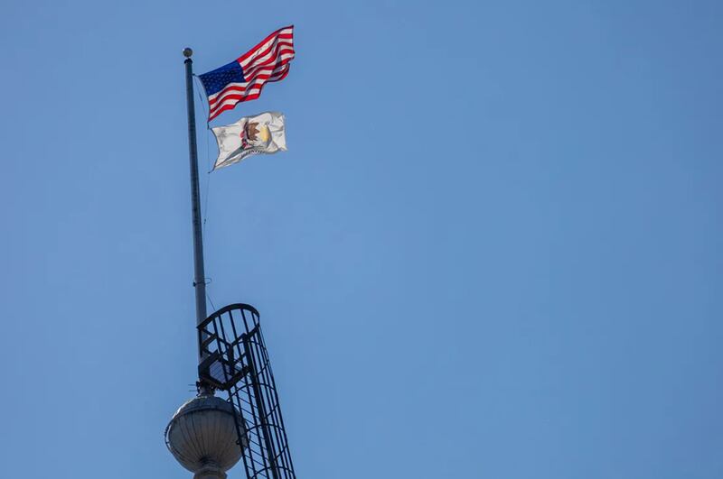 Flags fly atop the Illinois Capitol dome