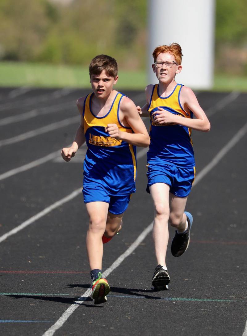 Princeton Logan's Parker Nink and Ethan Mallory run the 1600 meters in Bureau County Junior High School track meet.