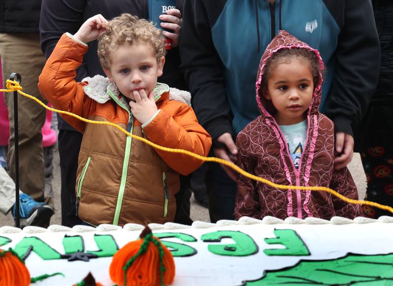 Visitors can hardly stand it as they wait for the cake cutting Wednesday, Oct. 22, 2025, during opening day of the Sycamore Pumpkin Festival.