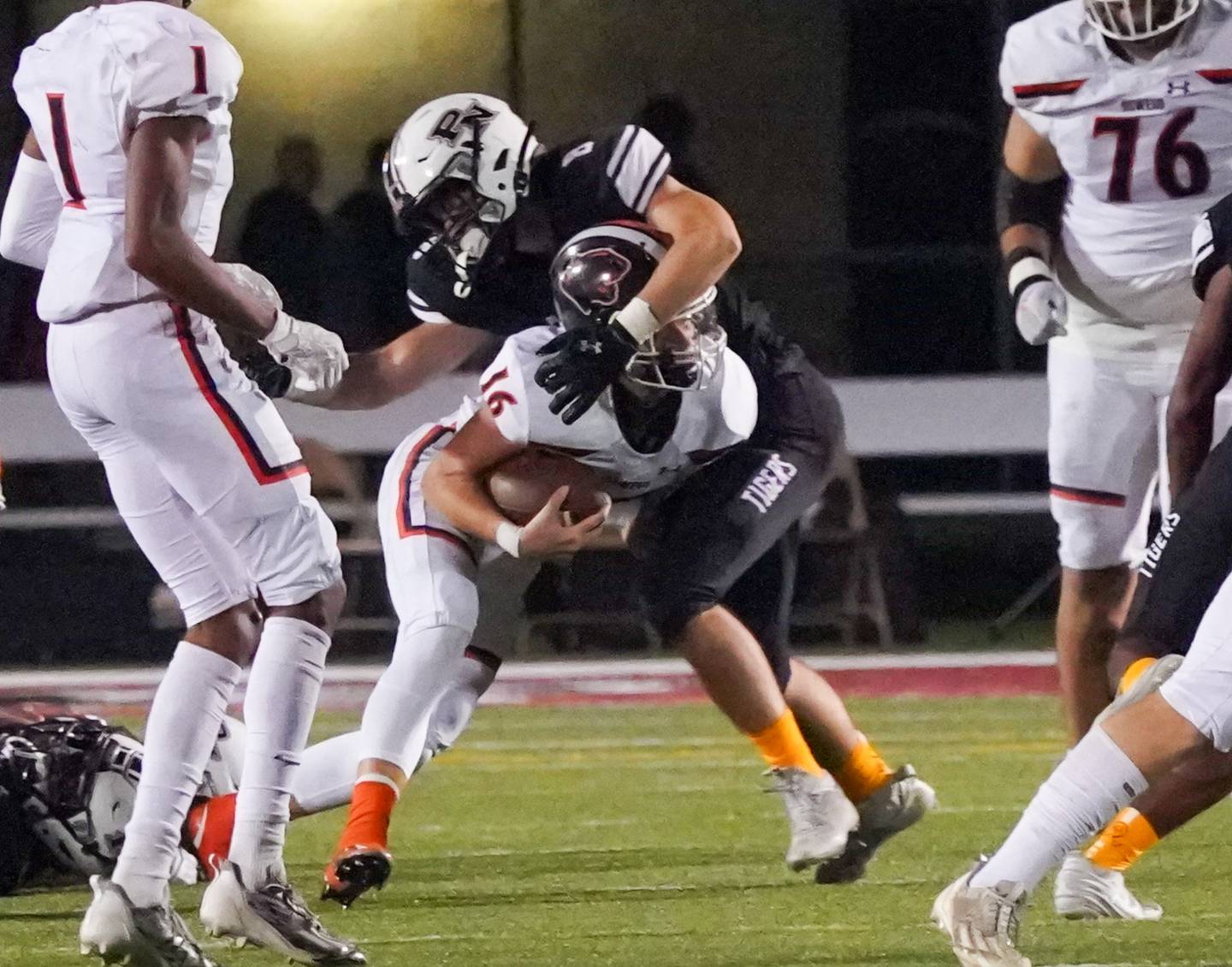 Plainfield North's Ryan Pass (8) hits Oswego’s Brett Connolly (16) in the backfield for a loss during a football game at Plainfield North High School on Friday, Sept. 22, 2023.