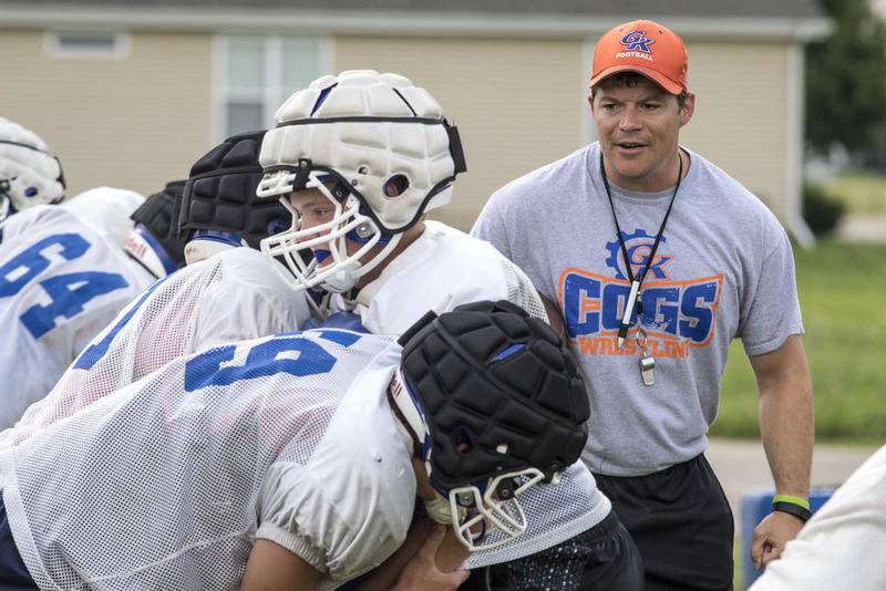 Head Coach Chad Wilmarth runs blocking drills on Thursday August 10, 2017