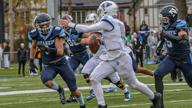 Nazareth's Nolan Daly (9, left) chases down St. Francis quarterback Brady Palmer during the Class 5A semifinal at La Grange Park.