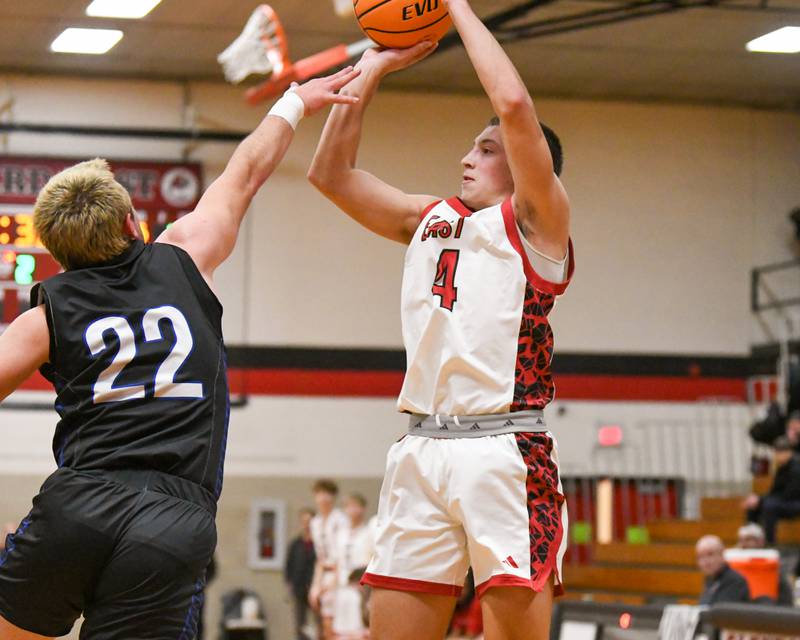 Riverside Brookfield's Evan Elzy (4) takes a shot while being defended by Riverside Brookfield's Benjamin Biskupic (22) during the game on Friday Dec. 19, 2025, held at Glenbard East High School.