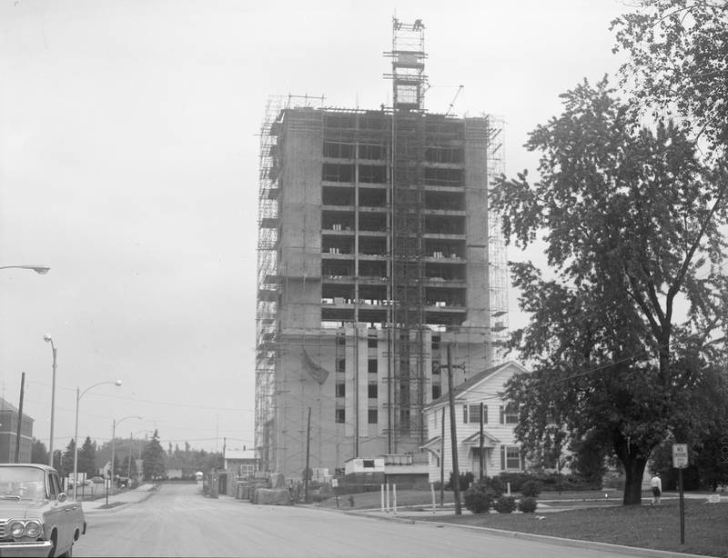 Construction of the Holmes Student Center tower at Northern Illinois University looking north on Carroll Avenue toward Lucinda Avenue, June 1967.