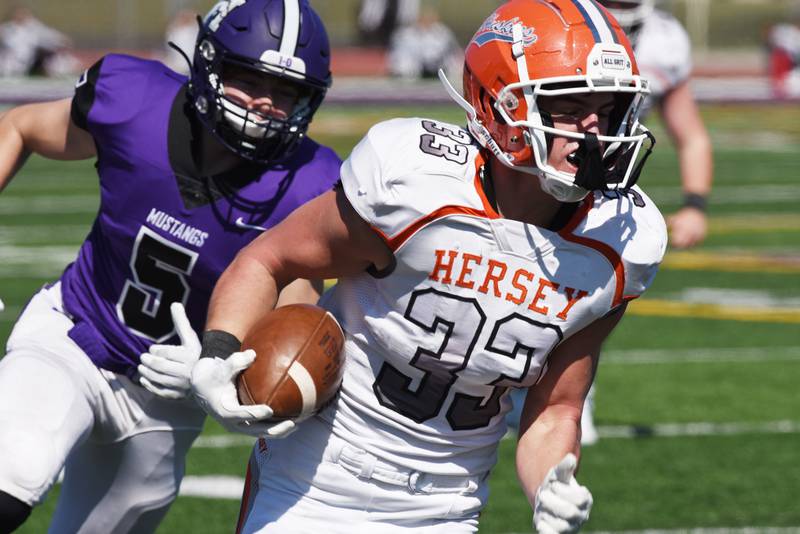 Hersey's Ben Clawson is ahead of Rolling Meadows' Collin Fennelly as he carries the ball for a second-quarter touchdown during Saturday's game at Rolling Meadows.
